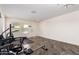 Bright home gym featuring exercise equipment, wood-look tile flooring, and access to an exterior door at 18318 W Pueblo Ave, Goodyear, AZ 85338