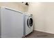 Convenient laundry room with front loading washer and dryer, tile floor and a wire shelf at 18318 W Pueblo Ave, Goodyear, AZ 85338