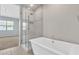 Bathroom featuring freestanding tub and glass enclosed shower at 1900 N 140Th Dr, Goodyear, AZ 85395
