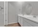 Bathroom features a double sink vanity with white cabinets, a large oval mirror and tile flooring at 1900 N 140Th Dr, Goodyear, AZ 85395