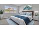 Comfortable bedroom with a bed, large window, and serene artwork for a peaceful ambiance at 1900 N 140Th Dr, Goodyear, AZ 85395
