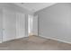Bedroom featuring neutral carpet, paint, and closet with sliding doors at 1900 N 140Th Dr, Goodyear, AZ 85395