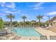 Resort-style community pool with clear water, comfortable lounge chairs, and palm trees for relaxation at 1900 N 140Th Dr, Goodyear, AZ 85395