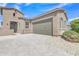 Charming home features desert landscaping, paver driveway, and a two-car garage at 1900 N 140Th Dr, Goodyear, AZ 85395