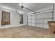 Large garage with an automatic door and concrete floors provides ample parking and storage at 1900 N 140Th Dr, Goodyear, AZ 85395