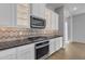 Kitchen featuring modern stainless steel appliances, ample cabinet space, and tiled backsplash at 1900 N 140Th Dr, Goodyear, AZ 85395