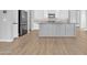 Modern kitchen featuring a large island, stainless steel appliances, and sleek cabinetry at 1900 N 140Th Dr, Goodyear, AZ 85395