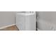 Bright laundry room features white washer and dryer appliances with tile flooring at 1900 N 140Th Dr, Goodyear, AZ 85395