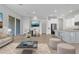 Inviting living space features a modern sofa, sleek coffee table, and a dining area with stylish chairs at 1900 N 140Th Dr, Goodyear, AZ 85395