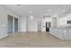 Open-concept living area with an island and bright white kitchen cabinetry with an inviting atmosphere at 1900 N 140Th Dr, Goodyear, AZ 85395