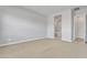 Large main bedroom with carpet flooring that flows into a bathroom with a soaking tub at 1900 N 140Th Dr, Goodyear, AZ 85395