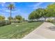 Scenic park with lush green grass, a walking path and mature trees with shade at 1900 N 140Th Dr, Goodyear, AZ 85395