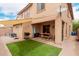 A backyard features a covered patio, artificial grass, and a privacy wall at 19043 E Seagull Dr, Queen Creek, AZ 85142