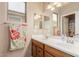 Bright bathroom featuring double sinks, wood cabinetry and a large mirror at 19043 E Seagull Dr, Queen Creek, AZ 85142