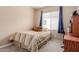 Cozy bedroom with neutral walls, plush carpeting, and a comfortable bed under a window with blue star curtains at 19043 E Seagull Dr, Queen Creek, AZ 85142