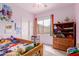 Charming bedroom featuring lavender walls, plush carpeting, and colorful decor at 19043 E Seagull Dr, Queen Creek, AZ 85142