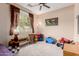 Spacious play room with plush carpeting, riding toys, and plenty of natural light at 19043 E Seagull Dr, Queen Creek, AZ 85142