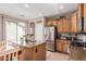 Bright kitchen with granite island, stainless refrigerator and gas range at 19043 E Seagull Dr, Queen Creek, AZ 85142
