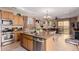 Open kitchen has stainless appliances and island with sink overlooking Gathering room at 19043 E Seagull Dr, Queen Creek, AZ 85142