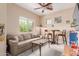 The living room features a comfortable sofa, natural light, and casual seating for relaxation at 19043 E Seagull Dr, Queen Creek, AZ 85142