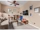 A cozy living room features neutral walls, a ceiling fan, and entertainment setup for relaxation at 19043 E Seagull Dr, Queen Creek, AZ 85142