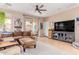 Inviting living room featuring a comfortable sectional sofa, a large television, and tiled floors at 19043 E Seagull Dr, Queen Creek, AZ 85142