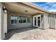 Inviting covered back patio with brick accents and an overhead ceiling light at 23063 W Loma Linda Blvd, Buckeye, AZ 85326