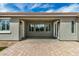 Covered patio area featuring brick flooring and access doors at 23063 W Loma Linda Blvd, Buckeye, AZ 85326