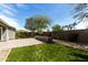 Backyard featuring artificial turf, brick accents, and desert landscaping at 23063 W Loma Linda Blvd, Buckeye, AZ 85326