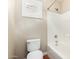 Bathroom with white tiled shower and bathtub and window with white plantation shutters at 23063 W Loma Linda Blvd, Buckeye, AZ 85326