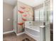 Elegant bathroom featuring a separate shower and tub, complemented by a unique poppy wall design for a touch of personality at 23063 W Loma Linda Blvd, Buckeye, AZ 85326