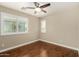 Light-filled bedroom with wood floors, ceiling fan and white plantation shutters on the windows at 23063 W Loma Linda Blvd, Buckeye, AZ 85326
