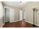 Bedroom with wood floors, modern lamp, closet and view into the hall at 23063 W Loma Linda Blvd, Buckeye, AZ 85326