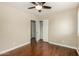 Bright bedroom with wood floors, ceiling fan, closet and view of adjacent room at 23063 W Loma Linda Blvd, Buckeye, AZ 85326