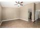 Bedroom with tile floors and ceiling fan provides a calm space with an entryway leading to the ensuite bathroom at 23063 W Loma Linda Blvd, Buckeye, AZ 85326