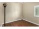 Cozy bedroom with wood floors, modern lamp, and window with plantation shutters at 23063 W Loma Linda Blvd, Buckeye, AZ 85326