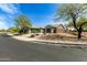 Exterior of a home featuring a three-car garage, desert landscaping, and a corner lot at 23063 W Loma Linda Blvd, Buckeye, AZ 85326