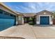 Inviting front entrance with a three-car garage, desert plants, and covered walkway leading to front door at 23063 W Loma Linda Blvd, Buckeye, AZ 85326