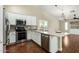 Modern kitchen features stainless steel appliances, ample counter space and stylish backsplash, blending functionality with design at 23063 W Loma Linda Blvd, Buckeye, AZ 85326