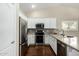 Modern kitchen featuring white cabinets, stainless steel appliances, and stylish backsplash at 23063 W Loma Linda Blvd, Buckeye, AZ 85326