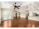 Open concept living space with hardwood floors, ceiling fans, and natural light, ideal for entertaining and everyday living at 23063 W Loma Linda Blvd, Buckeye, AZ 85326