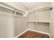 Bright walk-in closet with shelving and wooden floors, ready to be organized and filled with your wardrobe at 23063 W Loma Linda Blvd, Buckeye, AZ 85326