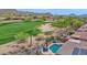 Aerial view of resort style backyard pool area overlooking the golf course and mountains at 2452 W Muirfield Dr, Anthem, AZ 85086