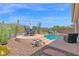 Picturesque backyard featuring a pool, outdoor seating, and natural desert landscaping with mountain views at 2452 W Muirfield Dr, Anthem, AZ 85086