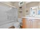 Well-lit bathroom featuring a tub-shower combo, vanity, and tiled floor at 2452 W Muirfield Dr, Anthem, AZ 85086