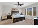 Bedroom featuring a ceiling fan, large window and a decorative painting above the bed at 2452 W Muirfield Dr, Anthem, AZ 85086