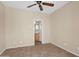 Neutral bedroom with tiled floor and door leading to the bathroom at 2452 W Muirfield Dr, Anthem, AZ 85086