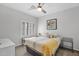Bright bedroom featuring a ceiling fan and a window bench near the bed at 2452 W Muirfield Dr, Anthem, AZ 85086
