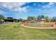 Community entrance featuring a water feature and lush green landscaping in Anthem at 2452 W Muirfield Dr, Anthem, AZ 85086