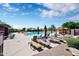 Community pool featuring lounge chairs, shaded seating and well-maintained landscaping at 2452 W Muirfield Dr, Anthem, AZ 85086